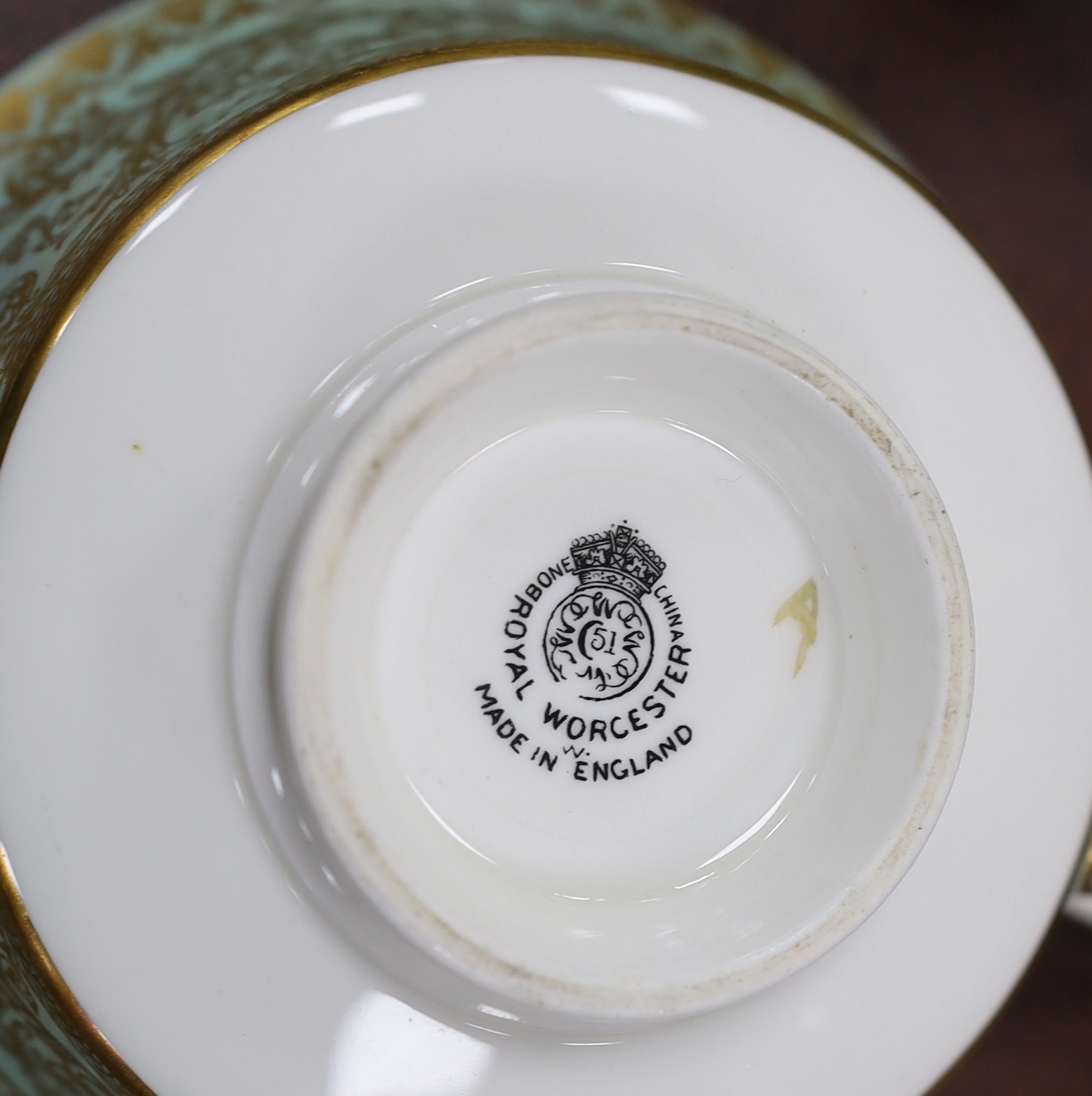 A Royal Worcester green and gilt decorated part dinner service